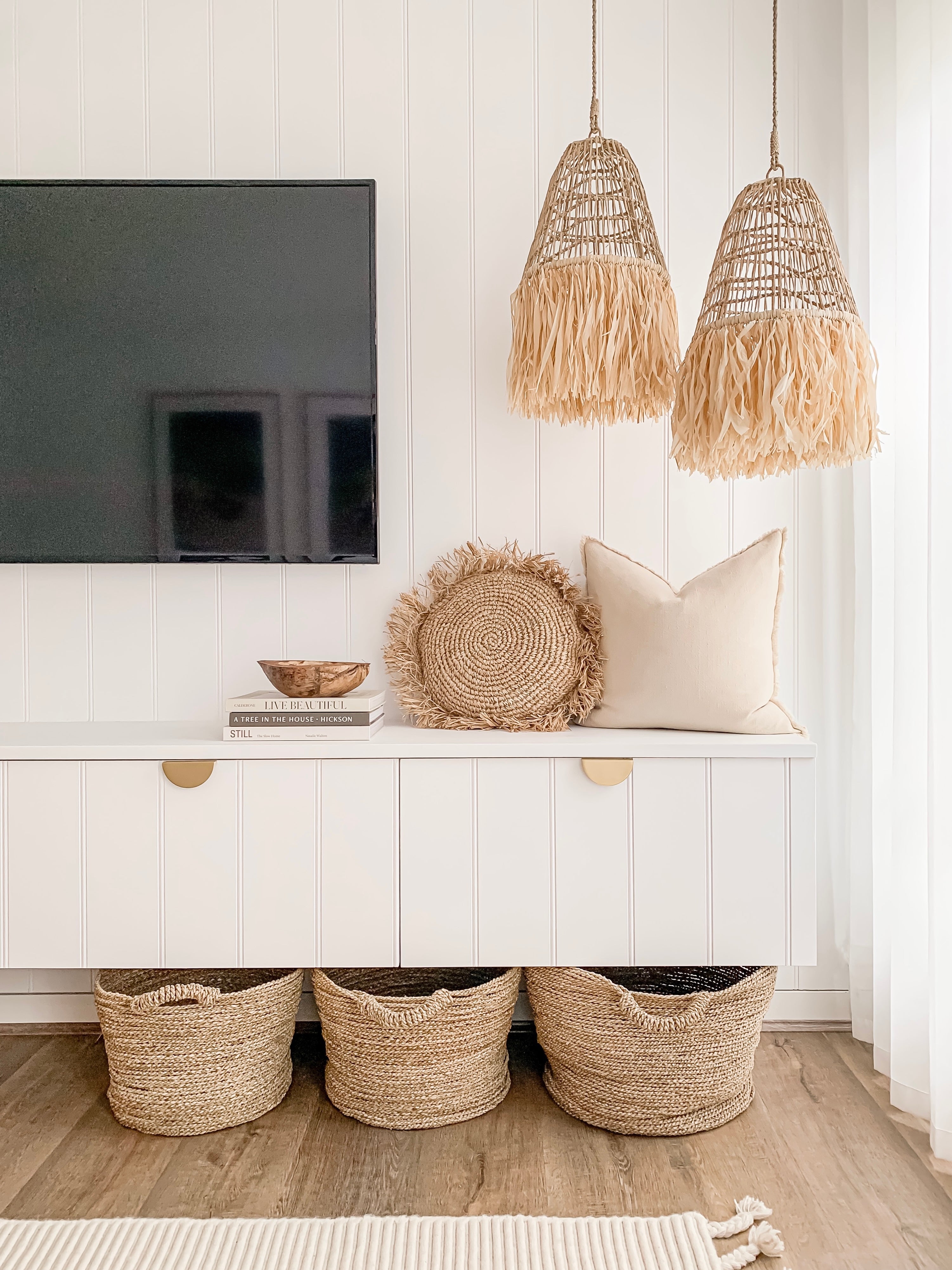 A modern living room with a TV and Ellie | Seagrass Pendant by Barre Living featuring natural textures.