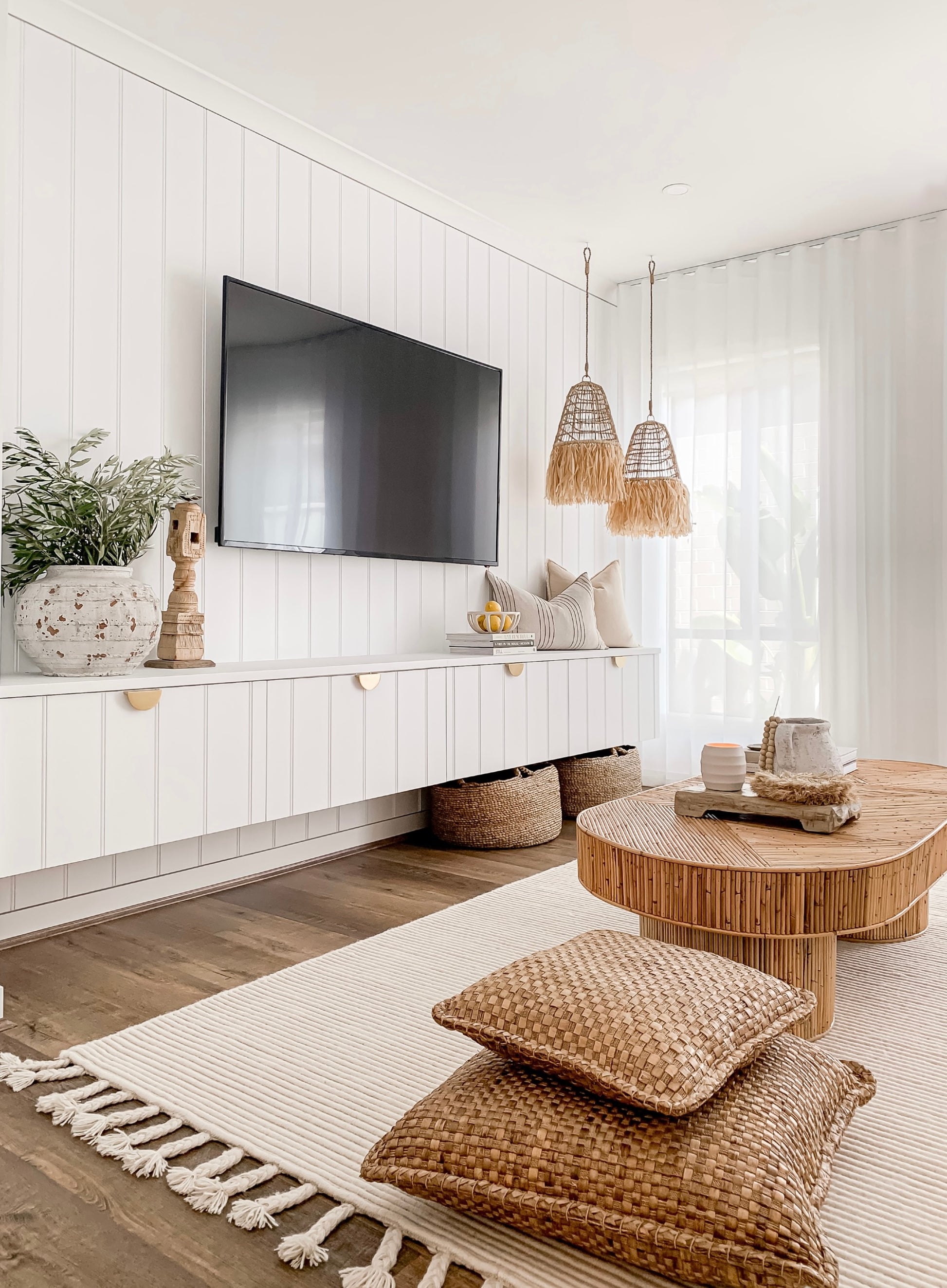 A white living room with natural textures and a Barre Living Ellie | Seagrass Pendant.