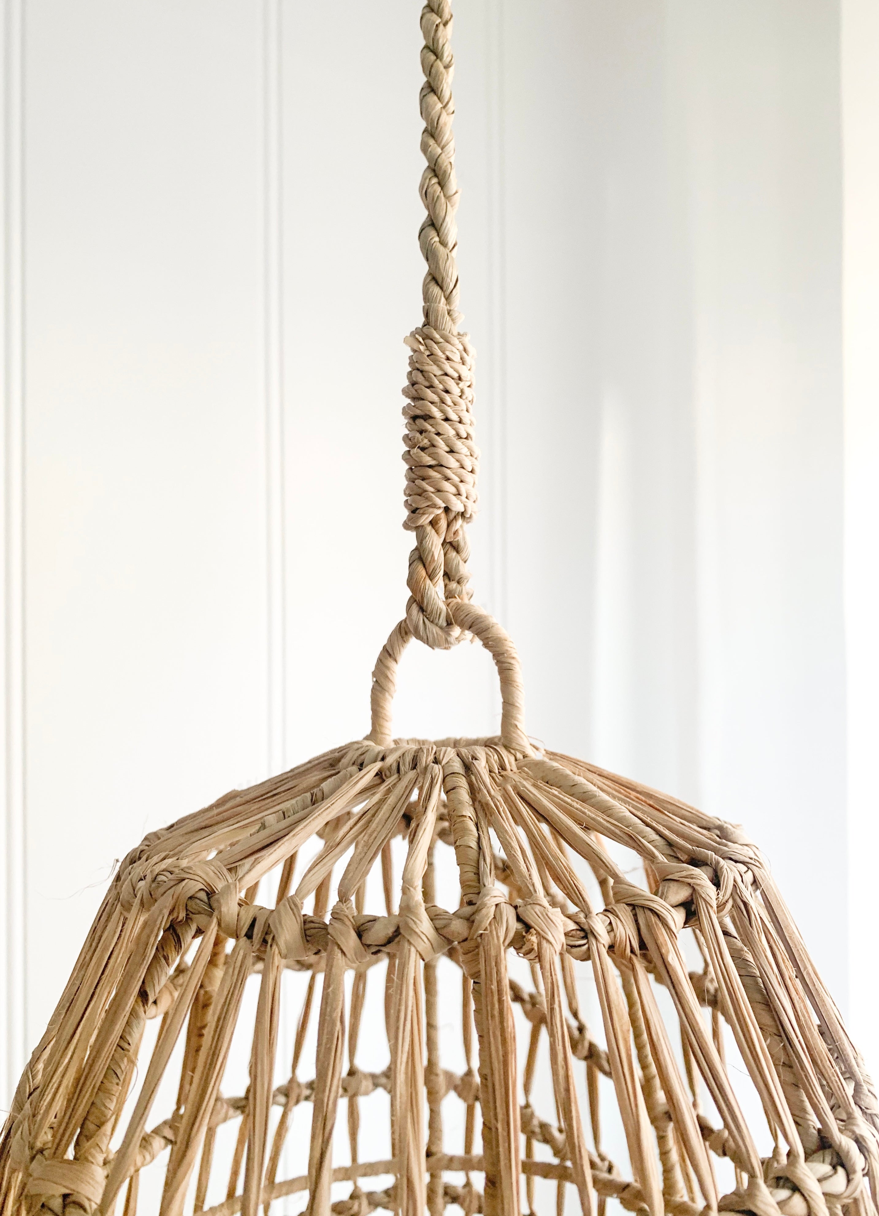 A modern design Ellie | Seagrass Pendant by Barre Living hanging on a wall.