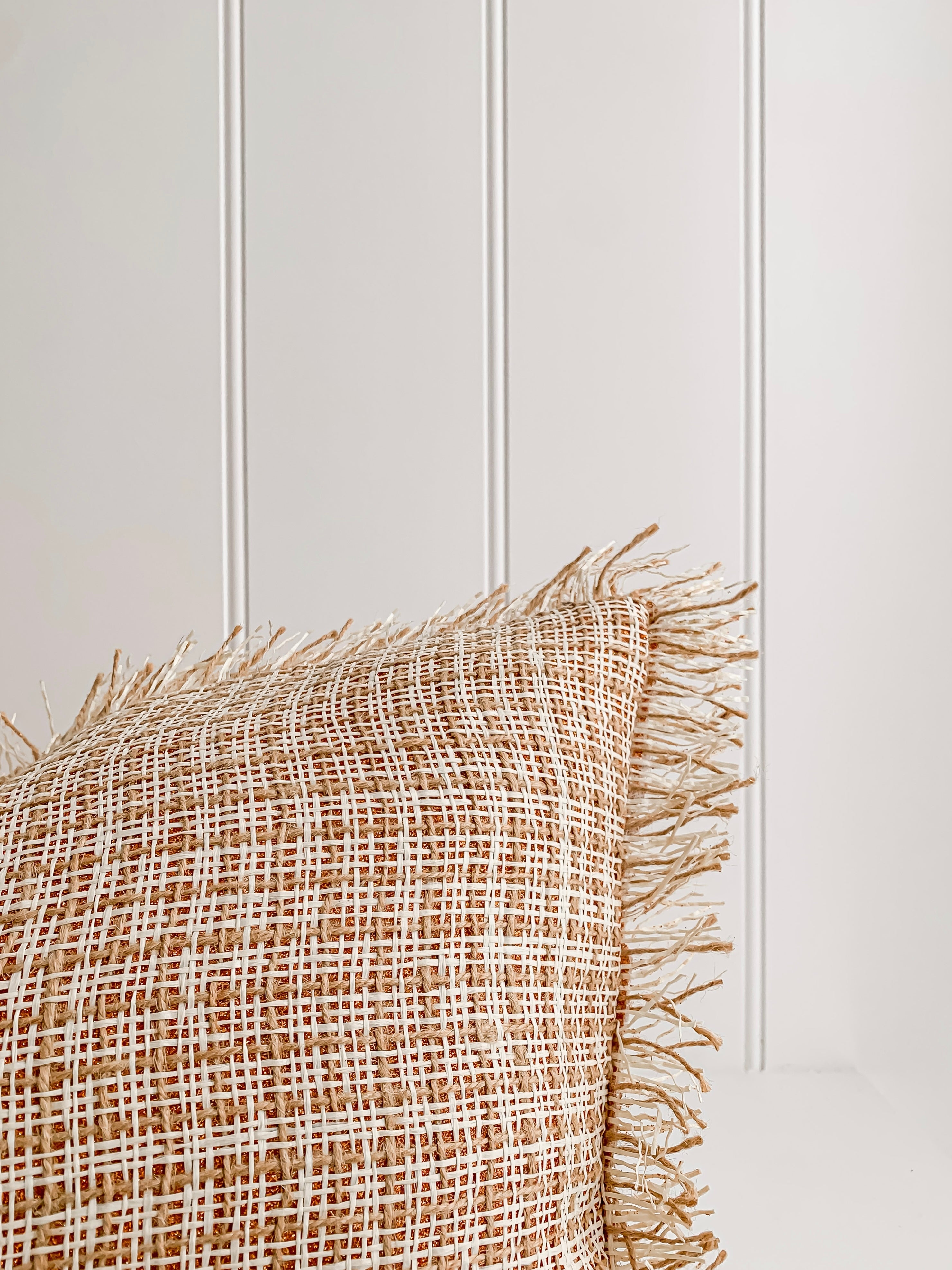 A Ava | Weave cushion by Barre Living with fringes.
