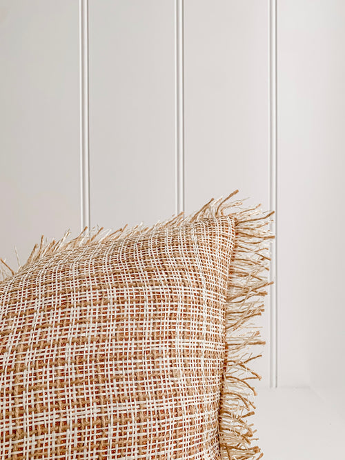 A Ava | Weave cushion by Barre Living with fringes.