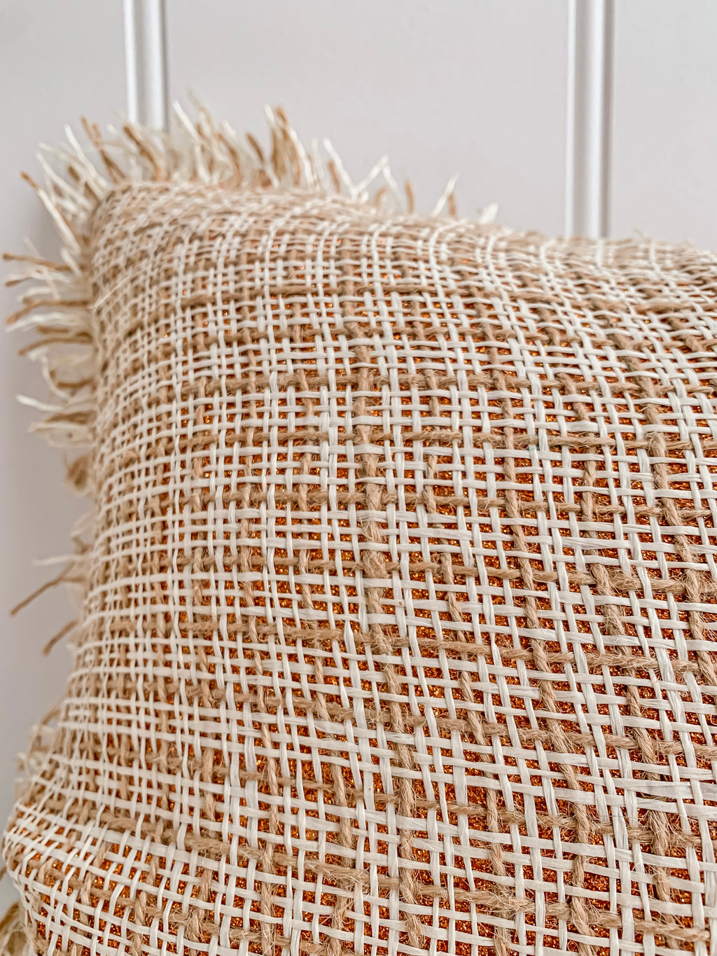 An elegant Ava | Weave cushion with tan fringes by Barre Living.