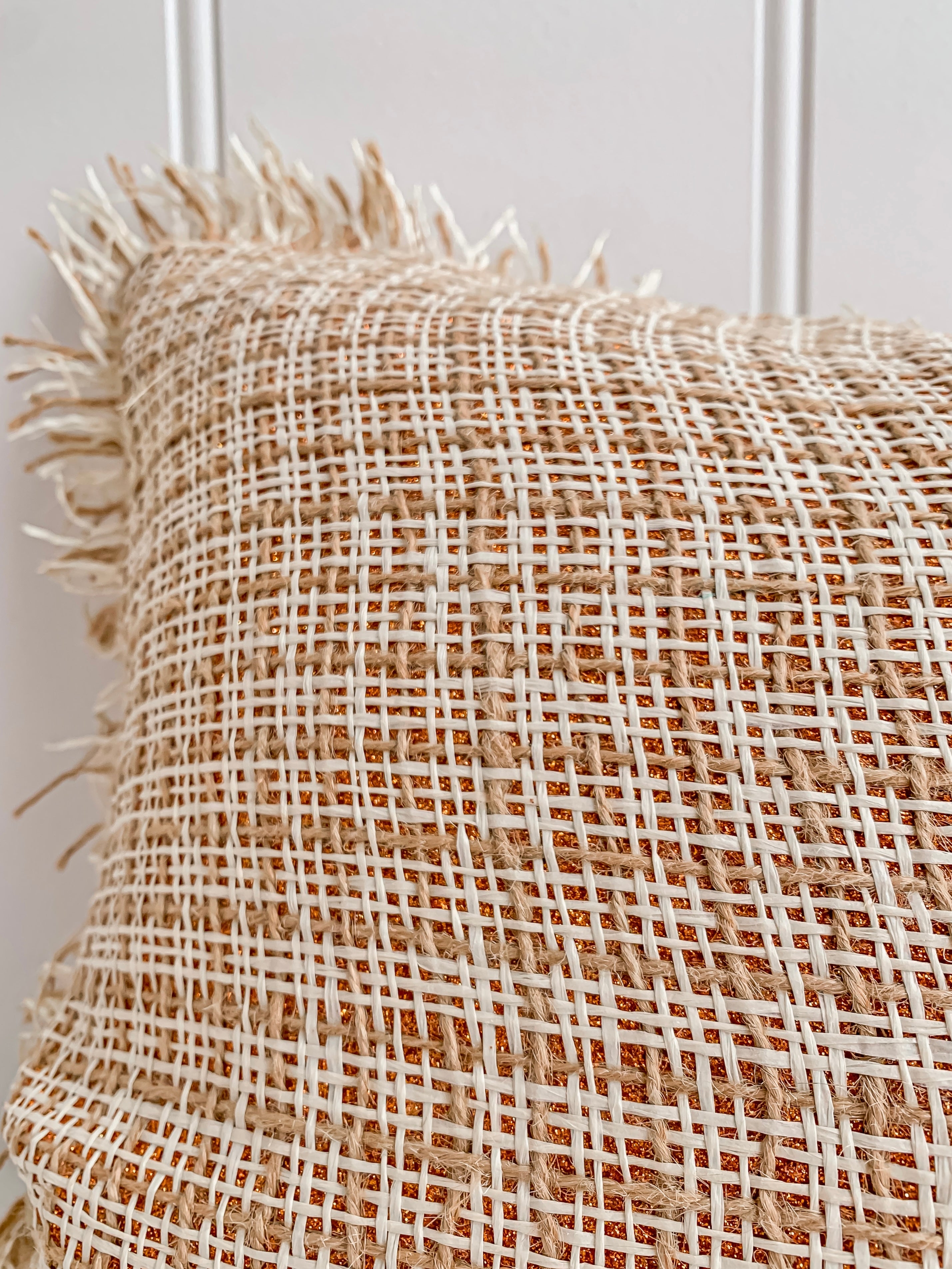 An elegant Ava | Weave cushion with tan fringes by Barre Living.