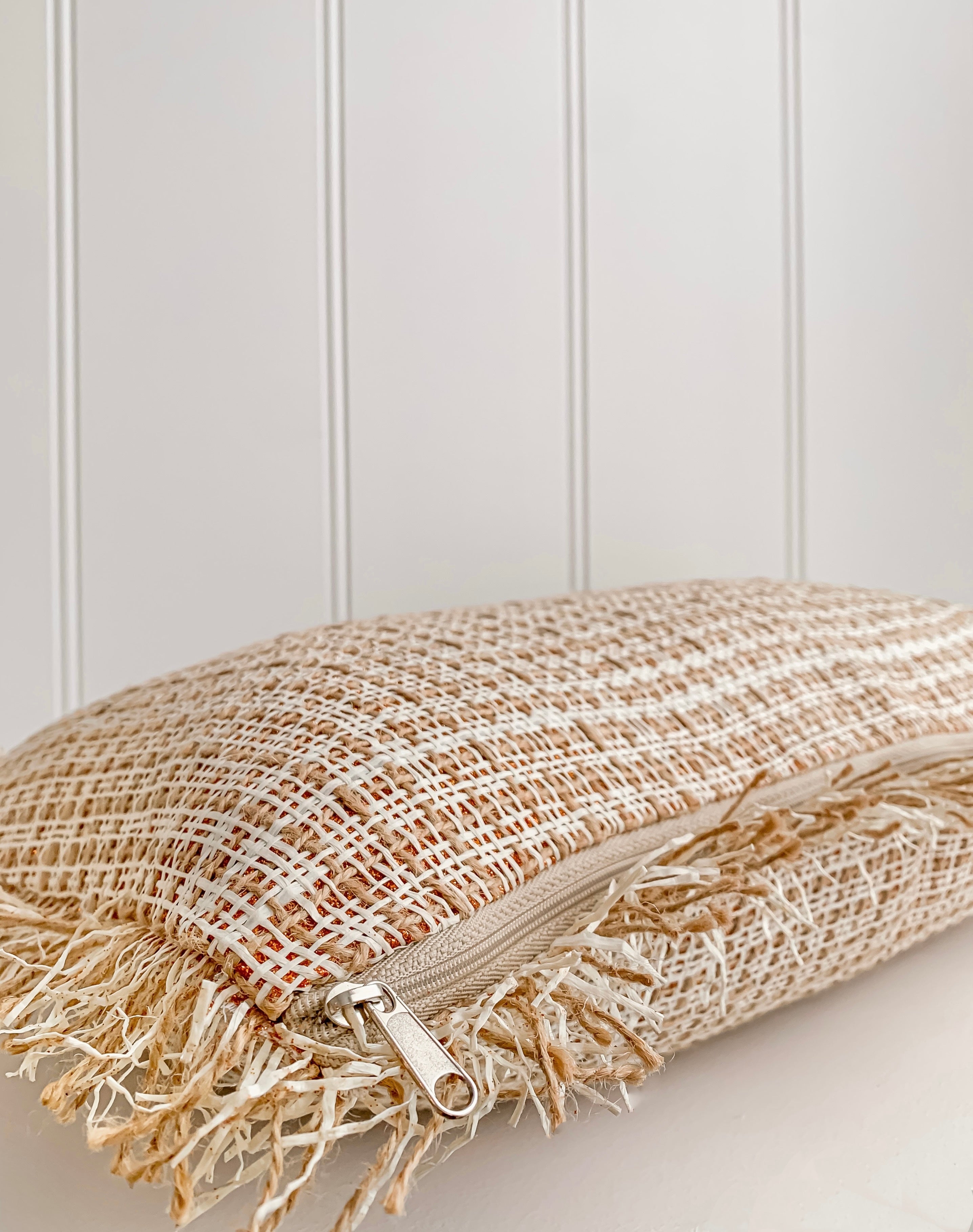 An Ava | Weave cushion by Barre Living, adorned with elegant fringes.